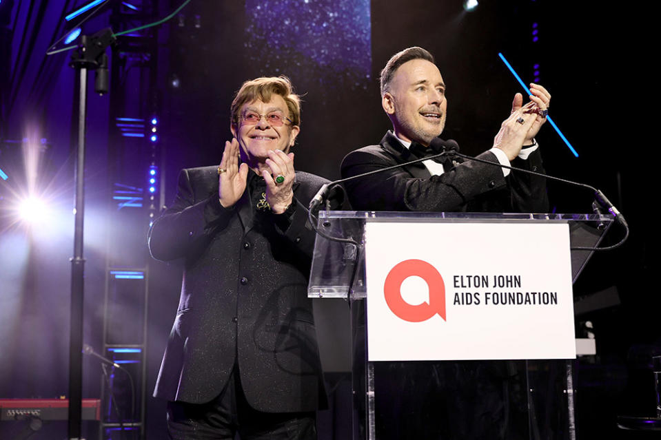 Elton John and David Furnish speak onstage at the Elton John AIDS Foundation's 32nd Annual Academy Awards Viewing Party on March 10, 2024 in West Hollywood, California.