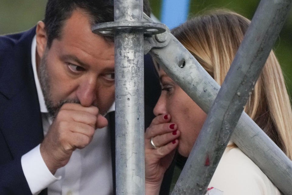 The League's Matteo Salvini, left, chats with Brothers of Italy's Giorgia Meloni on the stage of the center-right coalition closing rally in Rome Thursday, Sep. 22, 2022. Italians will vote on Sunday in what is being billed as a crucial election as Europe reels from repercussions of Russia's war in Ukraine. (AP Photo/Gregorio Borgia)