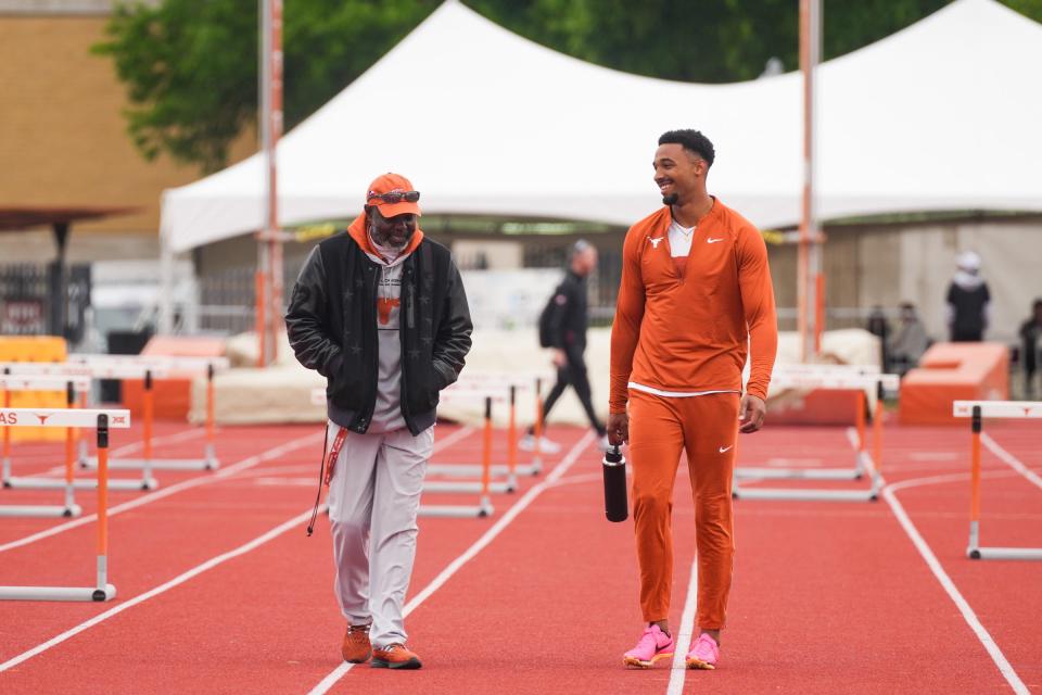 Texas track and field coach Edrick Floreal, left, talks with Leo Neugebauer during this year's Texas Relays. The Longhorns are competing in their final Big 12 championship meet this week in Waco.