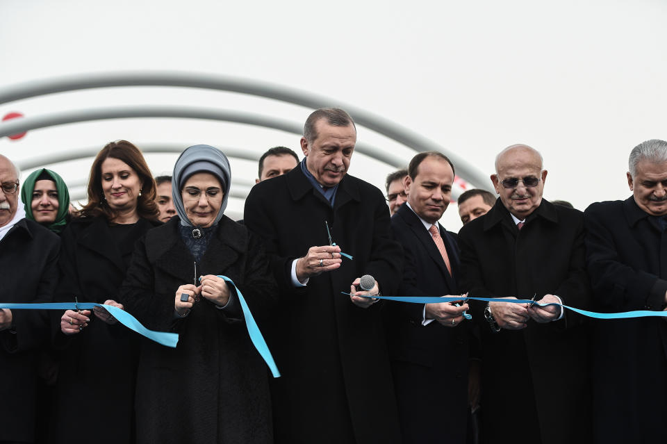 Turkish President Recep Tayyip Erdogan, center, with his wife Emine Erdogan by his side and Prime Minister Binali Yildirim, right, during the opening ceremony of a road tunnel underneath the Bosporus Strait in Istanbul in December 2016. | Ozan Kose—AFP/Getty Images