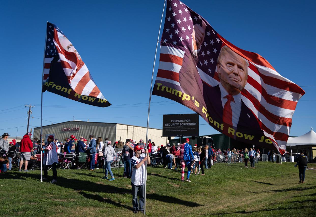 Adam Radogna, from Ohio, holds a large flag while waiting to enter Donald Trump’s Make America Great Again Rally in Waco, Texas, Saturday morning, March 25, 2023. Radogna travels to many of Donald Trump’s rallies as part of a group called “The Front Row Joes.” “We knew we needed to be here to support him,” Radogna said. “This is going to be big.”