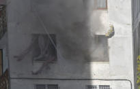 Smoke rises from windows of an apartment block during an operation to apprehend people who according to local media are suspected of terrorism, in Tbilisi, Georgia November 22, 2017. REUTERS/Irakli Gedenidze