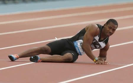 Yohan Blake of Jamaica falls injured in the men's 100m during the IAAF Diamond League athletics meeting at Hampden Park in Glasgow July 11, 2014. REUTERS/Phil Noble