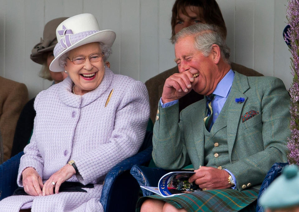 <p>The Queen and Prince Charles have a rare moment of uncontrolled laughter together as they take in a children's sack race at an event in Braemar, Scotland. </p>
