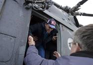 Flight engineer Sergei Ryazansky of Russia walks out of a helicopter upon his arrival in Karaganda, March 11, 2014. An American astronaut and two Russians who carried a Sochi Olympic torch into open space landed safely and on time on Tuesday in Kazakhstan, defying bad weather and ending their 166-day mission aboard the International Space Station (ISS). Inside the capsule were former ISS commander Oleg Kotov and flight engineers Ryazansky and Michael Hopkins from NASA. The trio launched together into space on September 25. REUTERS/Vasily Maximov/Pool (KAZAKHSTAN - Tags: TRANSPORT SCIENCE TECHNOLOGY)