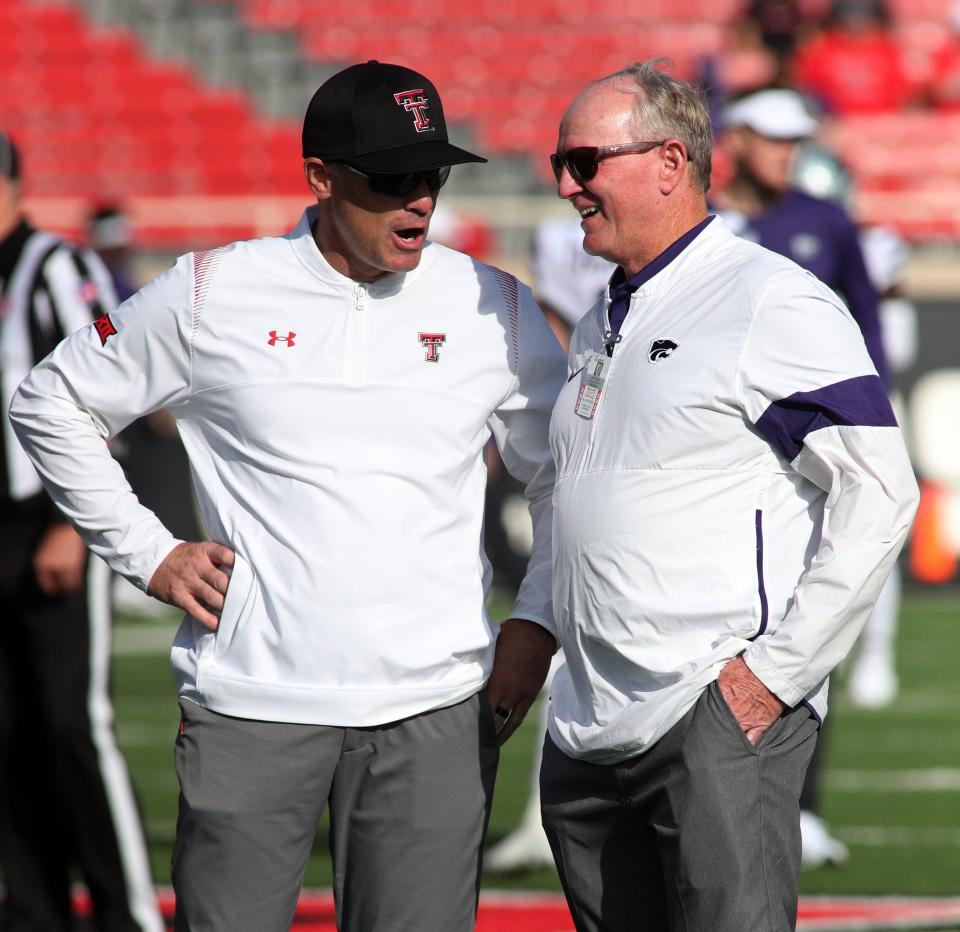 Kansas State football associate head coach Matt Wells, left, meets with Wildcats athletics director Gene Taylor before an October 2021 game in Lubbock, Texas, when Wells was head coach at Texas Tech.