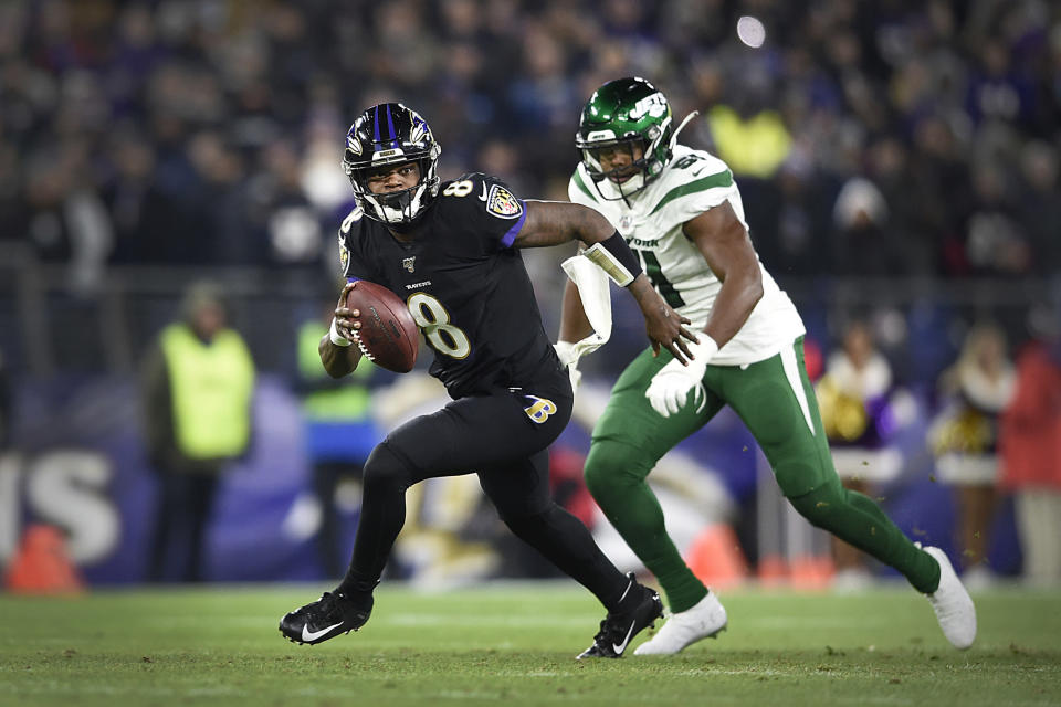 File-This Dec. 12, 2019, file photo shows Baltimore Ravens quarterback Lamar Jackson running during the first half of an NFL football game in Baltimore. No matter how many spectacular plays Jackson and Russell Wilson made, officiating overshadowed the NFL this season. (AP Photo/Gail Burton, File)