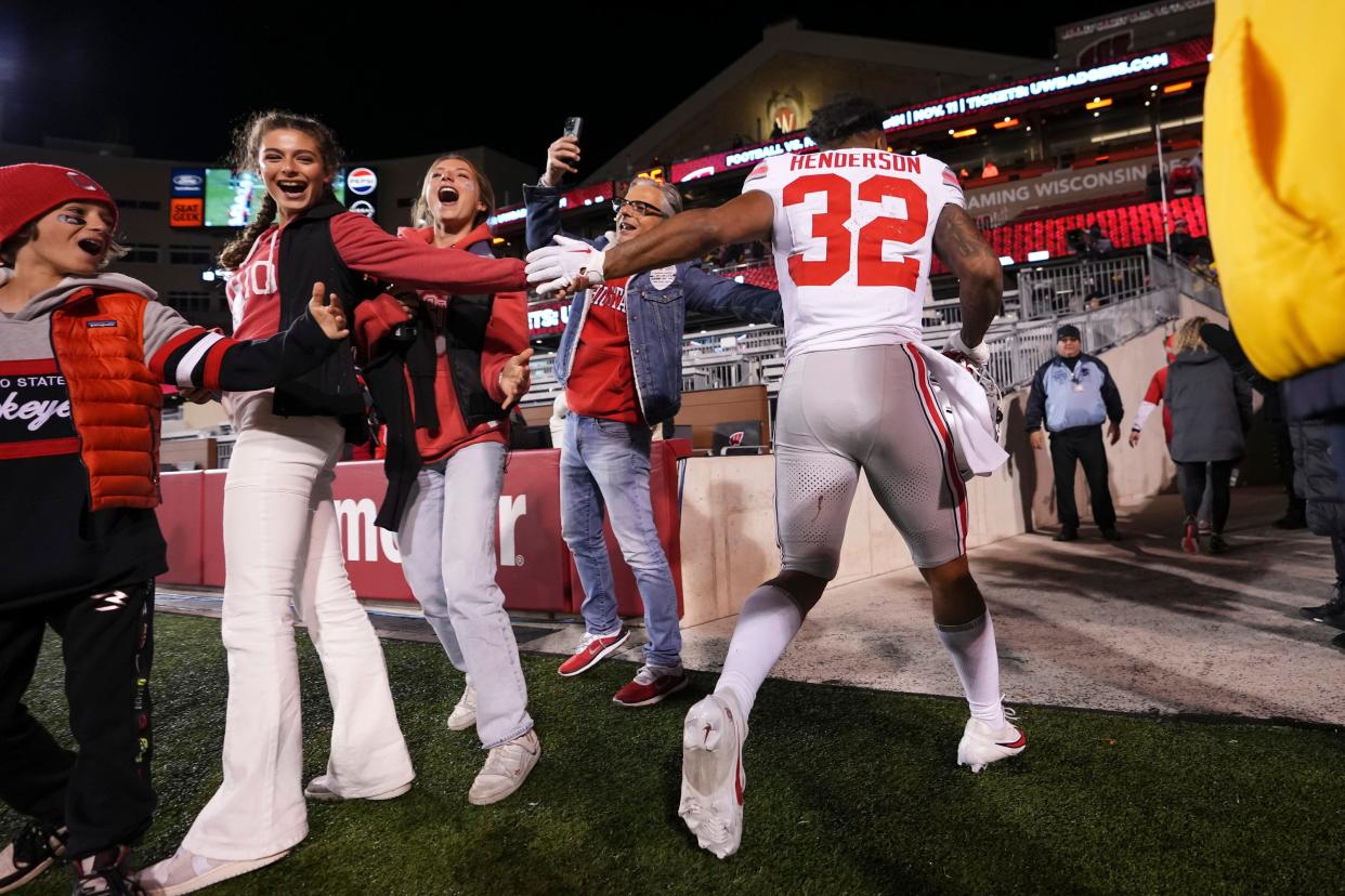 Ohio State running back TreVeyon Henderson gets high fives as he leaves the field on Saturday.