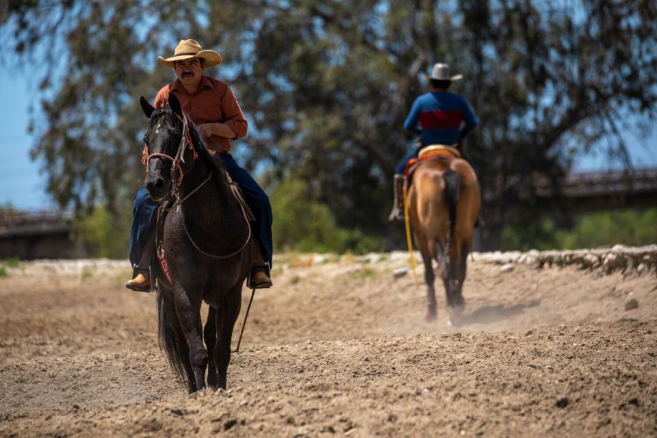 Two people on horseback.