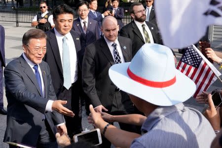 South Korean President Moon Jae-in (L) greets his supporters in Washington, U.S., June 28, 2017. REUTERS/Yuri Gripas