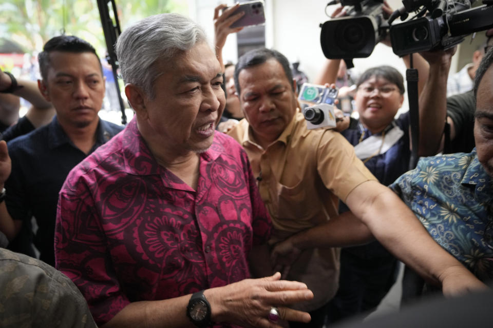 United Malays National Organization President Ahmad Zahid Hamidi, center, arrives at a party headquarters in Kuala Lumpur, Malaysia, Monday, Nov. 21, 2022. Malaysia's next government appears to be leaning to the religious right as a coalition of Malay nationalists won support of an influential bloc after tightly fought general elections failed to produce a clear winner. But opposition leader Anwar Ibrahim insists his reformist bloc has secured a simple majority. (AP Photo/Vincent Thian)