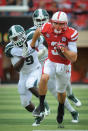 LINCOLN, NE - OCTOBER 29: Quarterback Taylor Martinez #3 of the Nebraska Cornhuskers runs away from safety Isaiah Lewis #9 of the Michigan State and the rest of the Spartan defense during their game at Memorial Stadium October 29, 2011 in Lincoln, Nebraska. Nebraska defeated Michigan State 24-3. (Photo by Eric Francis/Getty Images)