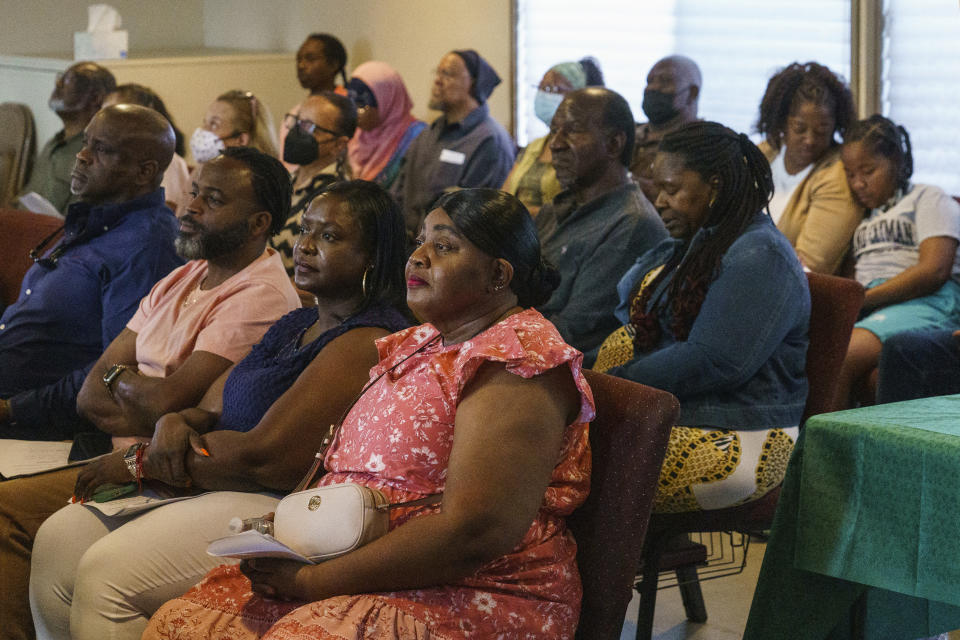 Descendants of Palm Springs Section 14 residents, front row from left, Durran Jamison, Jarvis Crawford, Janell Hunt, and Taunya Harvey gather at the United Methodist Church in Palm Springs, Calif., Sunday, April 16, 2023. Black and Latino Californians who were displaced from their Section 14 neighborhood in Palm Springs allege the city pushed them out by hiring contractors to destroy homes in an area that was tight-knit and full of diversity. (AP Photo/Damian Dovarganes)