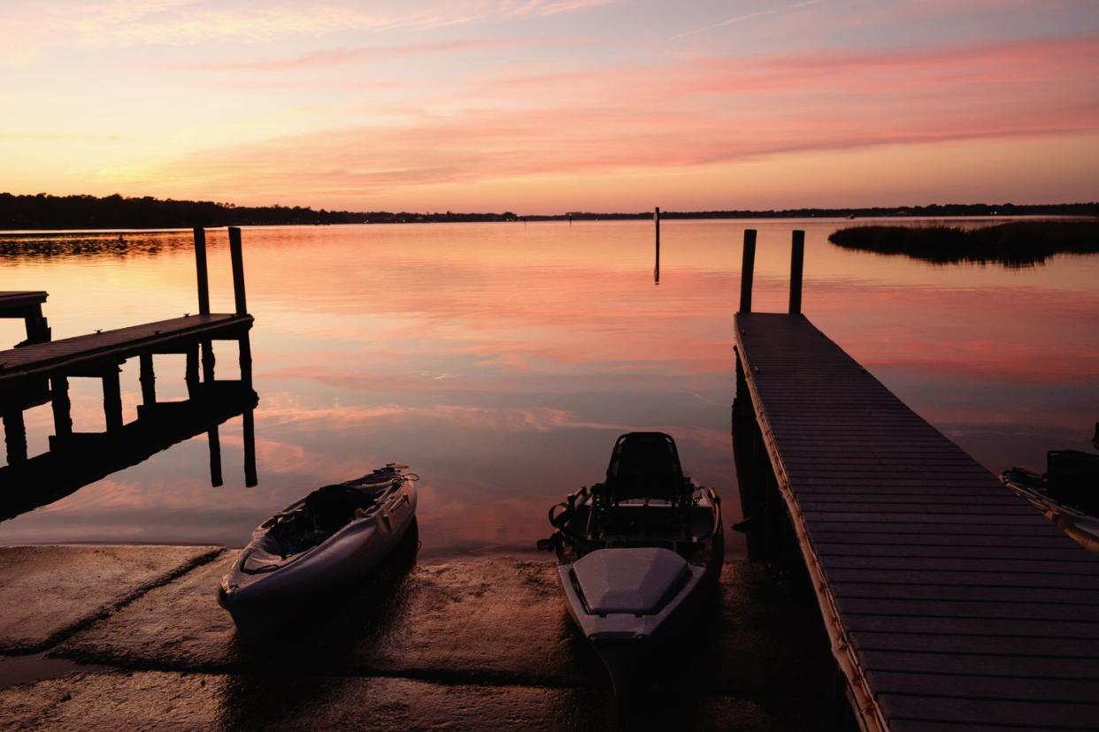 kayaks near dock at sunset