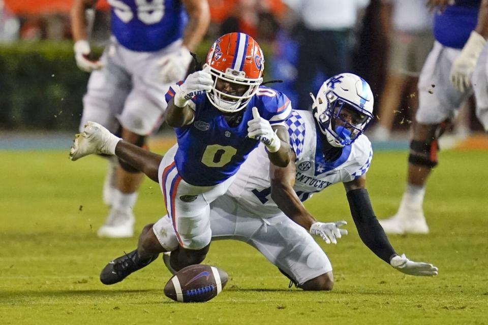 Florida wide receiver Ja'Quavion Fraziars drops a pass in front of Kentucky defensive back Carrington Valentine.