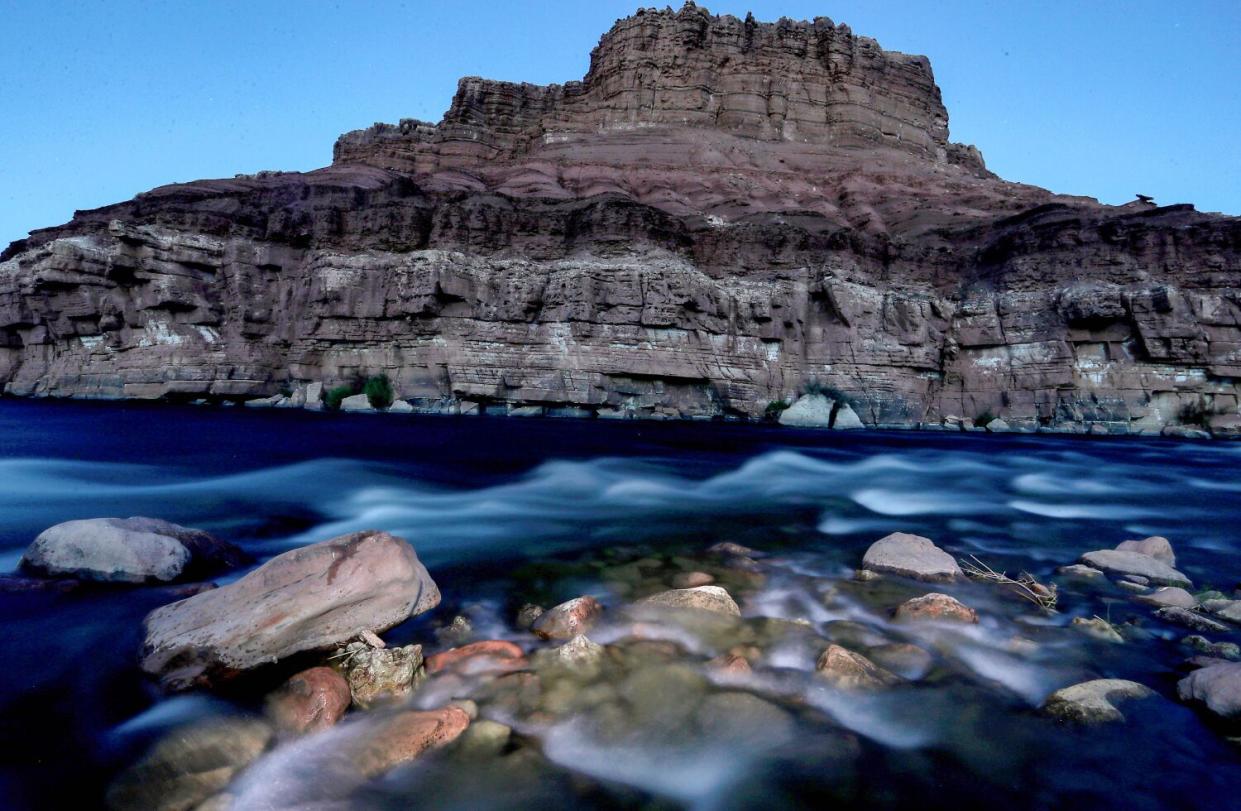 River water flows past a mesa