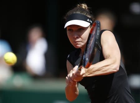 Simona Halep of Romania plays a shot to Evgeniya Rodina of Russia during their women's singles match at the French Open tennis tournament at the Roland Garros stadium in Paris, France, May 24, 2015. REUTERS/Vincent Kessler