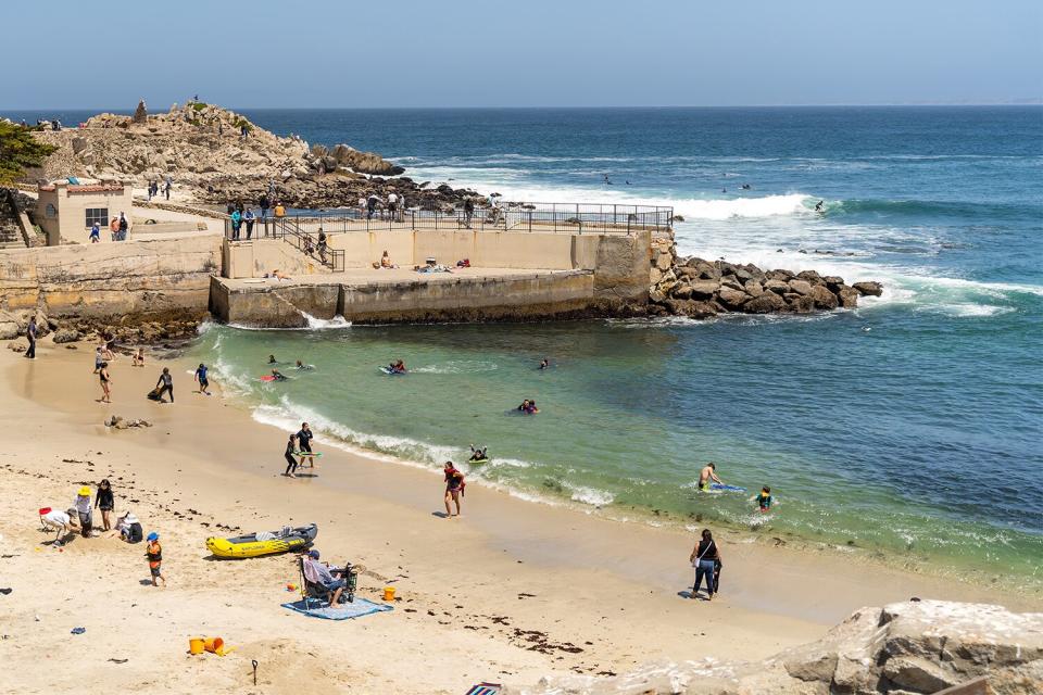 Monterey, CA, USA - May 2, 2021: People relaxing on the beach, Lovers Point Park ; Shutterstock