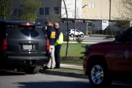 Law enforcement personnel attend the scene of a blast at a FedEx facility in Schertz, Texas, U.S., March 20, 2018. REUTERS/Sergio Flores