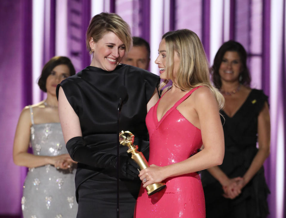 CORRECTS GERWIG'S CREDIT TO DIRECTOR AND CO-WRITER - This image released by CBS shows director and co-writer Greta Gerwig, left, and actor Margot Robbie accepting the award for best cinematic and box office achievement for the film "Barbie" during the 81st Annual Golden Globe Awards in Beverly Hills, Calif., on Sunday, Jan. 7, 2024. (Sonja Flemming/CBS via AP)