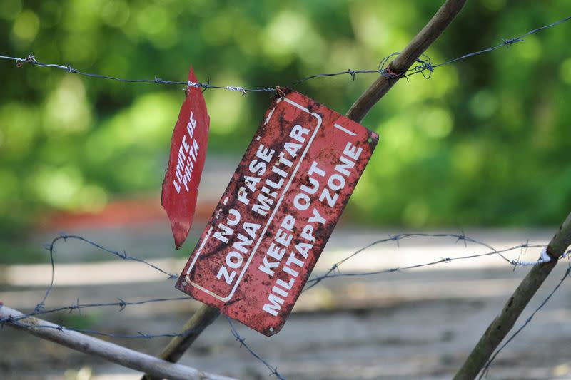 An improvised gate blocks the way leading to a Cuban military base near Bejucal, Cuba