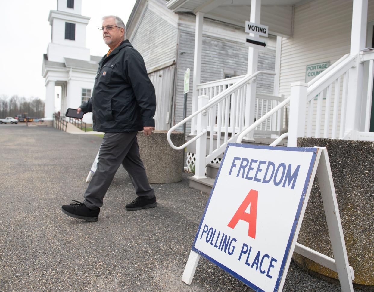 Voters at the polls in Portage and Summit counties. Paul Horbaly exits the Freedom Town Hall after voting.