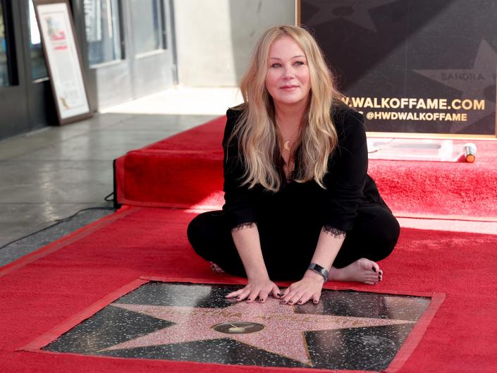 Christina Applegate poses with her star during her Hollywood Walk of Fame Ceremony at Hollywood Walk Of Fame on November 14, 2022.