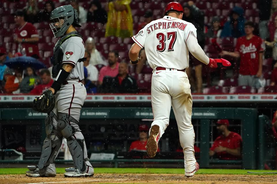 Cincinnati Reds catcher Tyler Stephenson (37) scores after Cincinnati Reds center fielder Albert Almora Jr. (3) hit a single in the seventh inning of a baseball game, Monday, June 6, 2022, at Great American Ball Park in Cincinnati. 