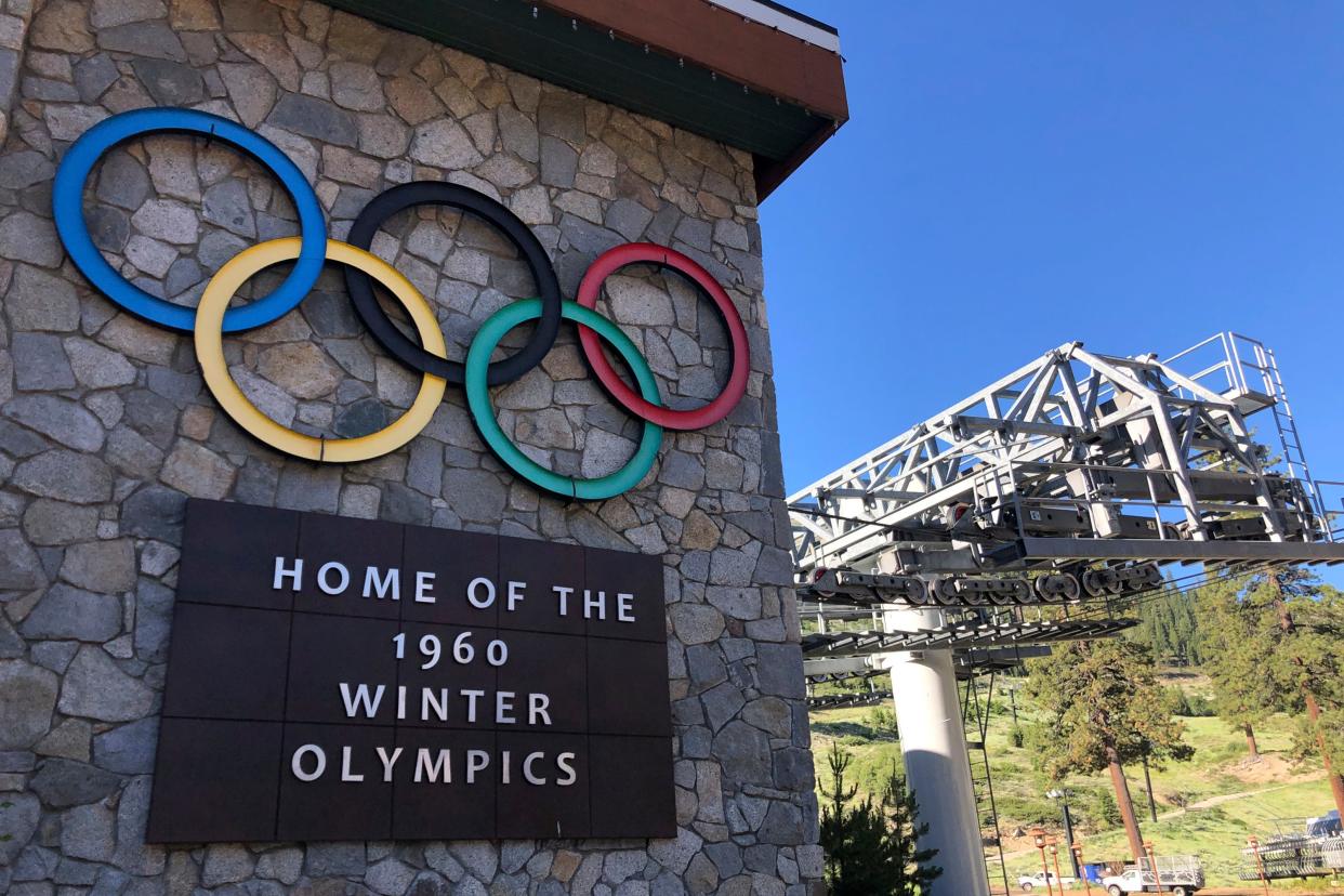 A sign marking the 1960 Winter Olympics is seen by a chairlift in Olympic Valley, California. The U.S. government has joined a ski resort and others that have quit using a racist term for a Native American woman by renaming hundreds of peaks, lakes, streams, and other geographical features on federal lands in the West and elsewhere.