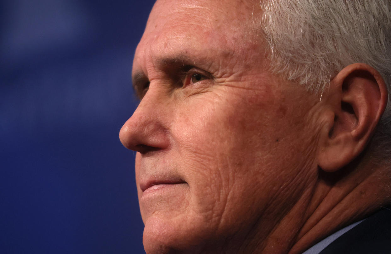 Close-up shot of Mike Pence's face against a blue background.