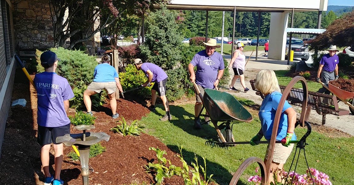 Volunteers work to spruce up the front of Apple Valley Middle as part of Day of Action in Henderson County in August 2019.