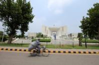 A man rides a bicycle past the Supreme Court building in Islamabad