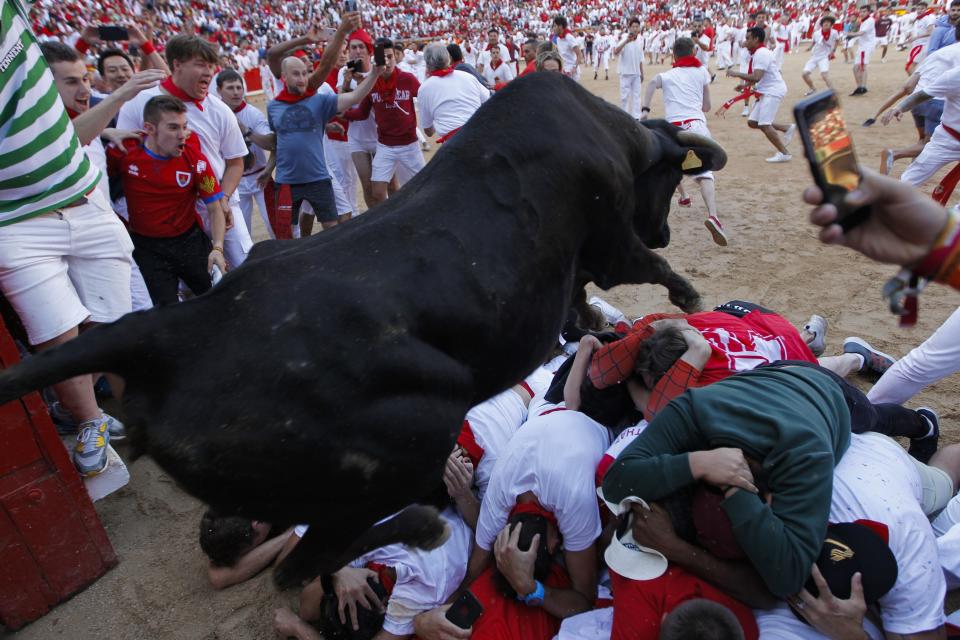 A cow jumps over revellers following the running of the bulls at the San Fermin Festival, in Pamplona, northern Spain, Wednesday, July 10, 2019.  (Photo: Alvaro Barrientos/AP)