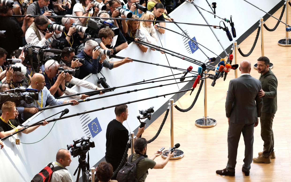 Ukraine's President Volodymyr Zelensky and European Council President Charles Michel speak with the media as they arrive for an EU summit in Brussels