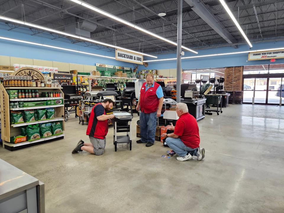 From left, Dakota Vaughan, Tony Downey and Mark Crosby put together a barbecue grill to be delivered to a customer. Southeast Ace Hardware opened Monday, March 6, 2023, at Midtown Market on Hardy Street in Hattiesburg.