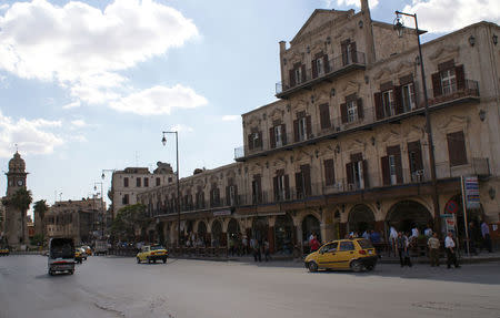 People walk near Aleppo's Bab al-Faraj Clock Tower, Syria October 6, 2010. REUTERS/Khalil Ashawi