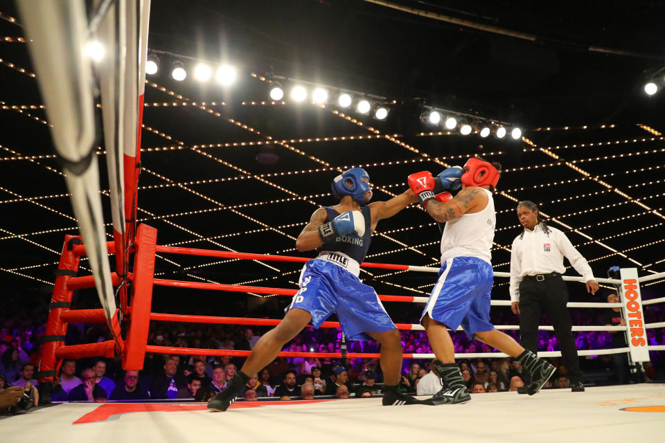 <p>Reshawn Merrick (blue) lands a punch on John Chalen (red) in the Bronx Precinct Callout during the NYPD Boxing Championships at the Hulu Theater at Madison Square Garden on March 15, 2018. (Gordon Donovan/Yahoo News) </p>