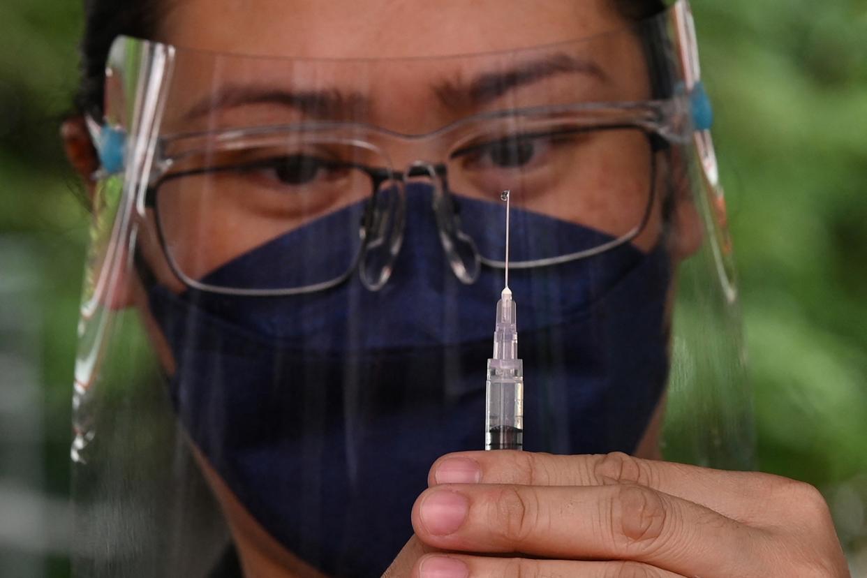 A medical worker prepares the BioNtech-Pfizer vaccine during an inoculation drive of young people aged 12 to 17 against the COVID-19 coronavirus, at a school in Taguig City, suburban Manila on November 10, 2021. (Photo: TED ALJIBE/AFP via Getty Images)