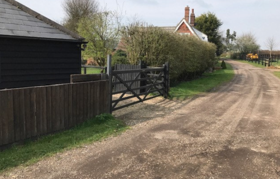 The fence lines along a private drive which lines the Hamblings' house in Polstead, Suffolk. (SWNS)