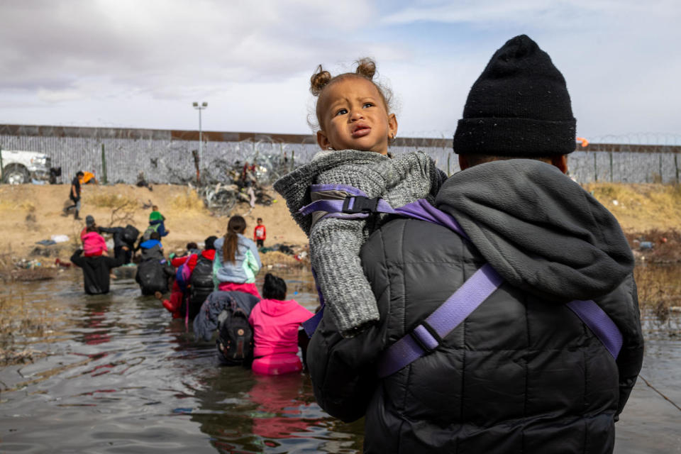 A migrant crosses the Rio Grande with his child attempting to reach the United States border in Ciudad Juarez, Mexico (David Peinado / Anadolu via Getty Images file )