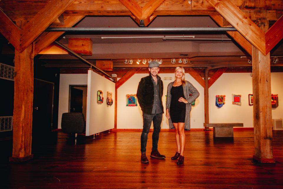 Joel Sager and Hannah Reeves, owners of Sager Reeves Gallery, pose for a portrait in their downtown art gallery.