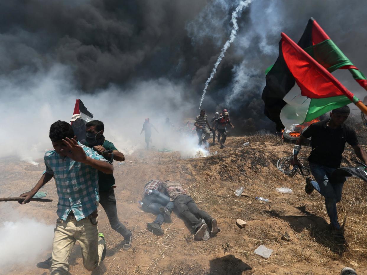 Palestinian protesters flee from Israeli tear gas at a demonstration in May: Reuters