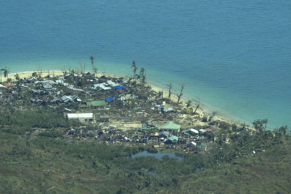 This photo provided by the Philippine Coast Guard, shows damaged houses caused by Typhoon Rai at a coastal village in Surigao del Norte province, southern Philippines on Friday, Dec. 17, 2021. A strong typhoon engulfed villages in floods that trapped residents on roofs, toppled trees and knocked out power in southern and central island provinces, where more than 300,000 villagers had fled to safety before the onslaught, officials said. (Philippine Coast Guard via AP)