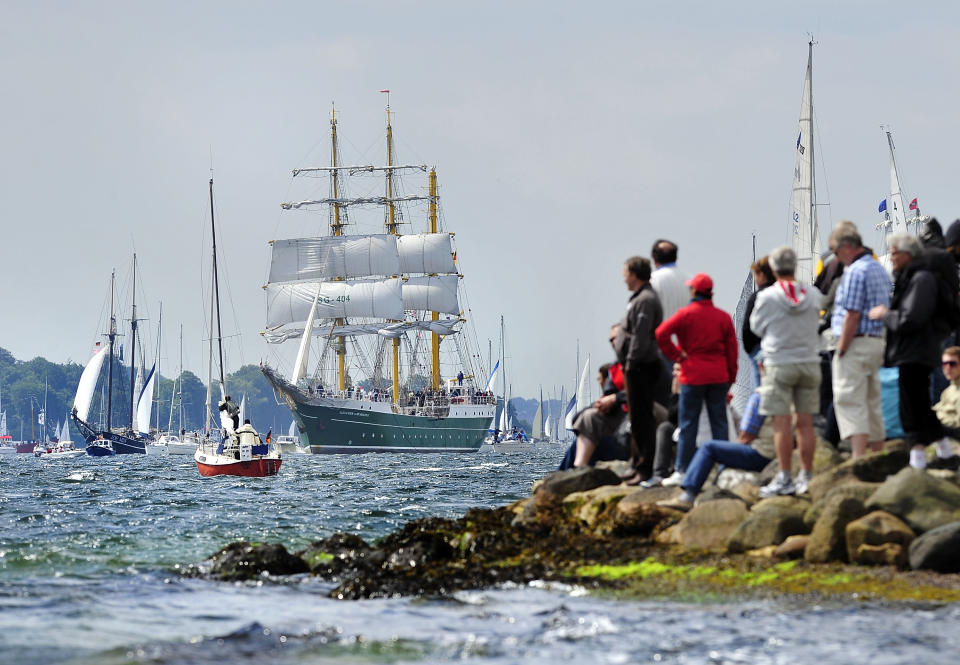 Visitors watch the "Alexander von Humboldt II" tall ship at the Windjammer Parade of tall ships on June 23, 2012 in Kiel, Germany. The parade, which features approximately 100 tall ships and traditional large sailing ships, is the highlight of the Kieler Woche annual sailing festival, which this year is celebrating its 130th anniversary and runs from June 16-24. (Photo by Patrick Lux/Getty Images)
