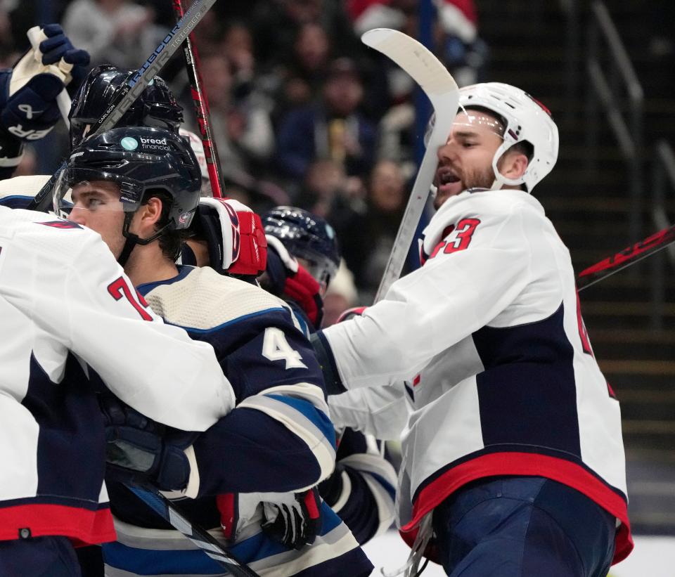 Dec. 201, 2023; Columbus, Ohio, USA; 
Washington Capitals right wing Tom Wilson (43) takes a stick to the face during a skirmish in front of the goal during the second period of a hockey game against the Columbus Blue Jackets at Nationwide Arena on Thursday.