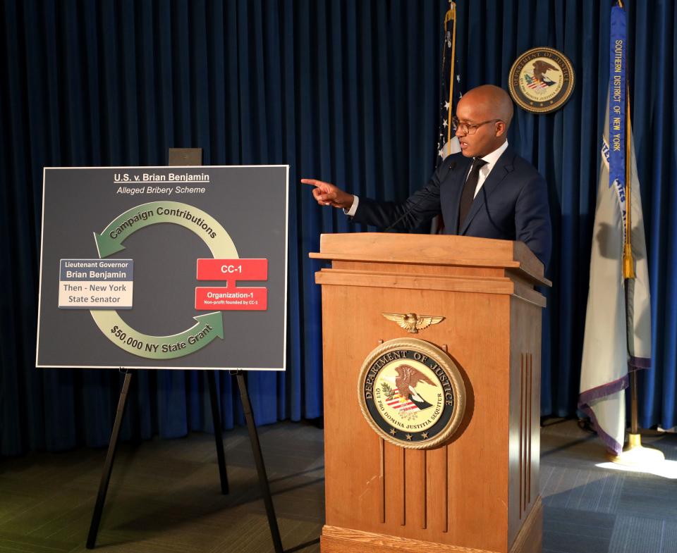 U.S Attorney for the Southern District of New York Damian Williams, displays a graphic outlining the federal conspiracy charges against New York Lt. Governor Brian Benjamin during a press conference in New York, April 12, 2022. Investigations. 