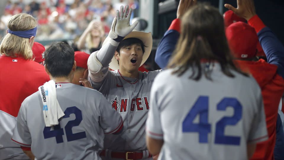 Ohtani is congratulated after hitting a home run in the fifth inning against the Texas Rangers. - Tim Heitman/Getty Images