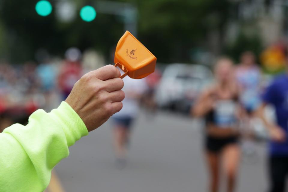 A spectator rings a cowbell to encourage runners near the finish of the 2022 Butte to Butte Run Eugene July 4, 2022.