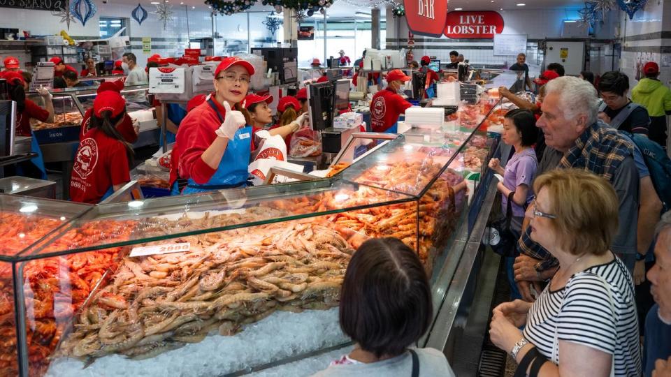 Customers buying prawns.