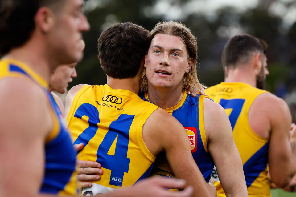 Harley Reid embraces his teammates.